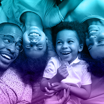 Affectionate,African,American,Parents,And,Cute,Small,Kids,Laughing,Lying